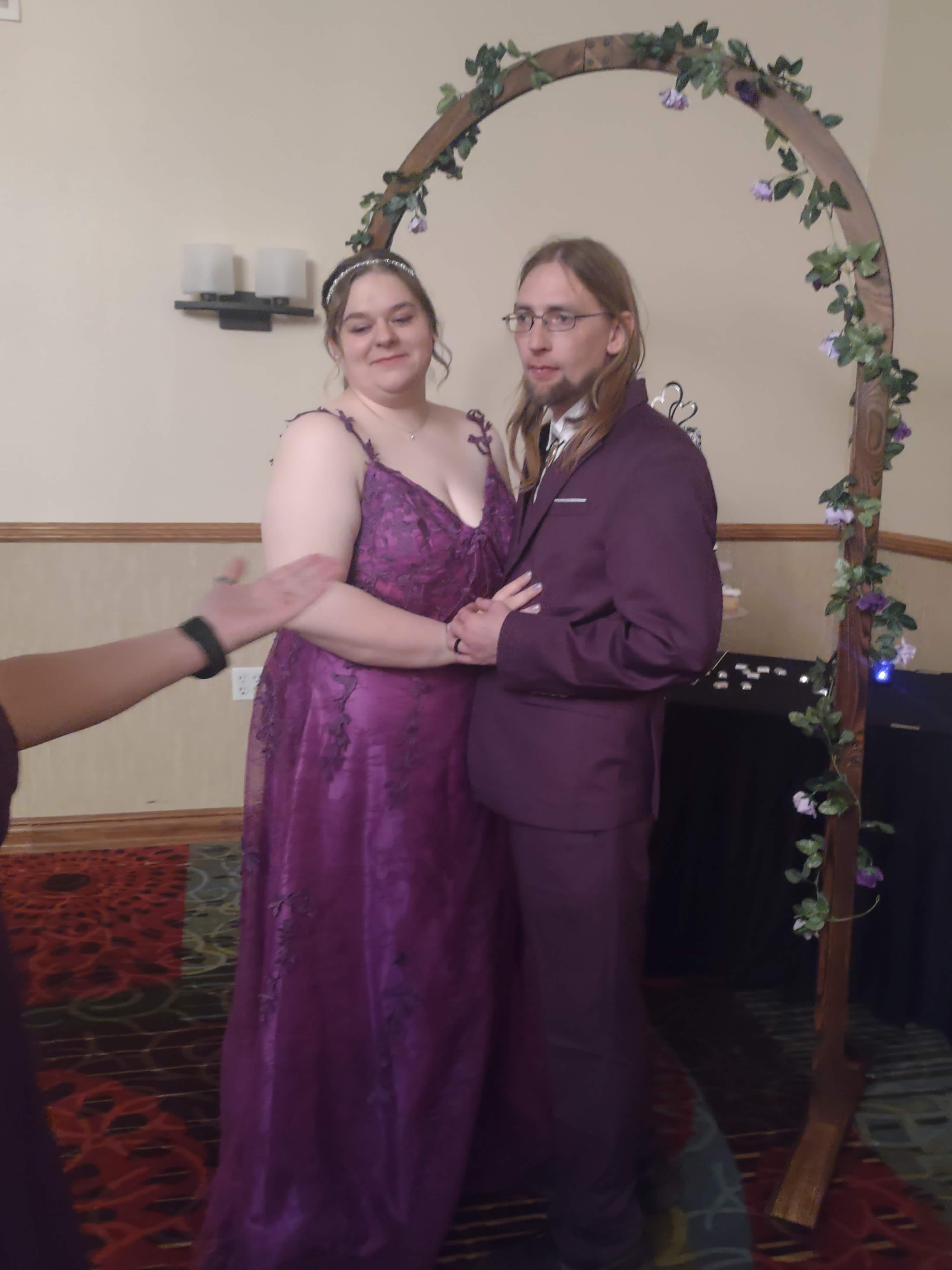 Couple following ceremony with wedding arch
